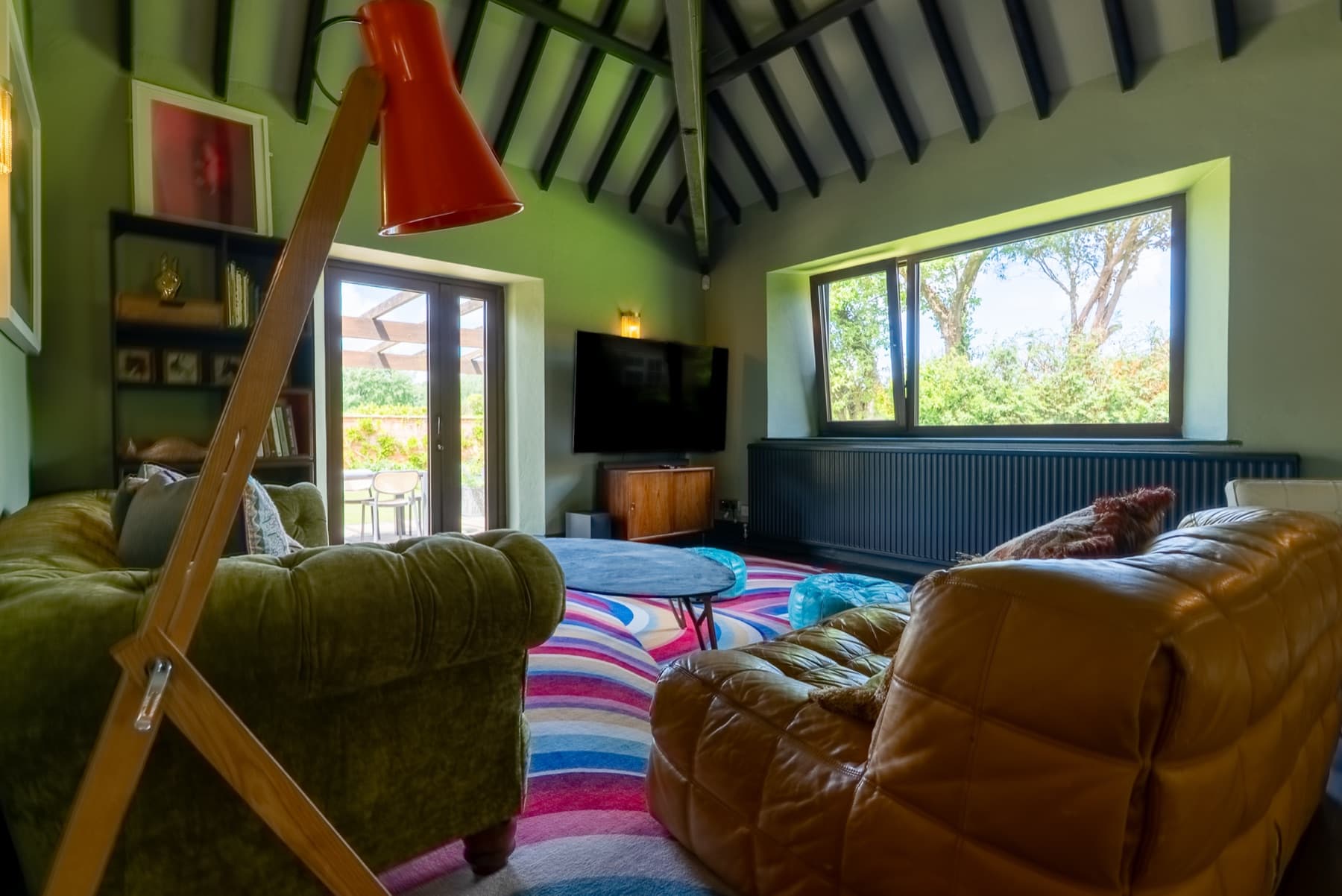 Living room, vaulted beams, cinema screen and reading lamp